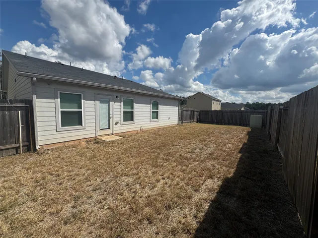 a view of house with backyard and garden