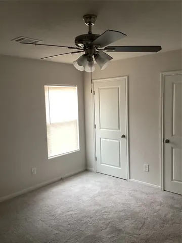 a view of a chandelier fan and a window in a room