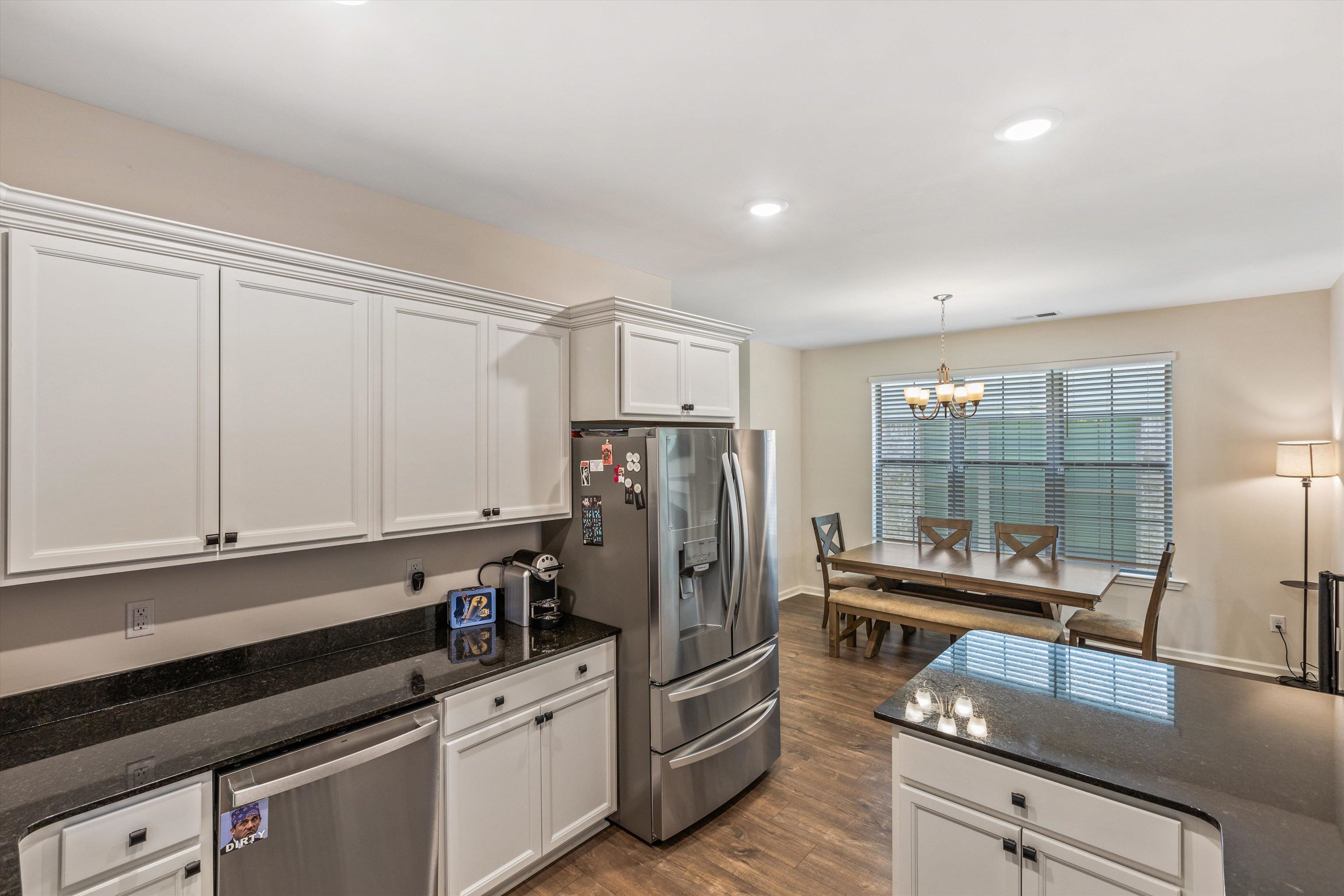 10139 Macon Road Cordova, TN 38018 - Photo 10 of 31 Kitchen featuring white cabinetry, dark stone countertops, stainless steel appliances, and wood-finish flooring