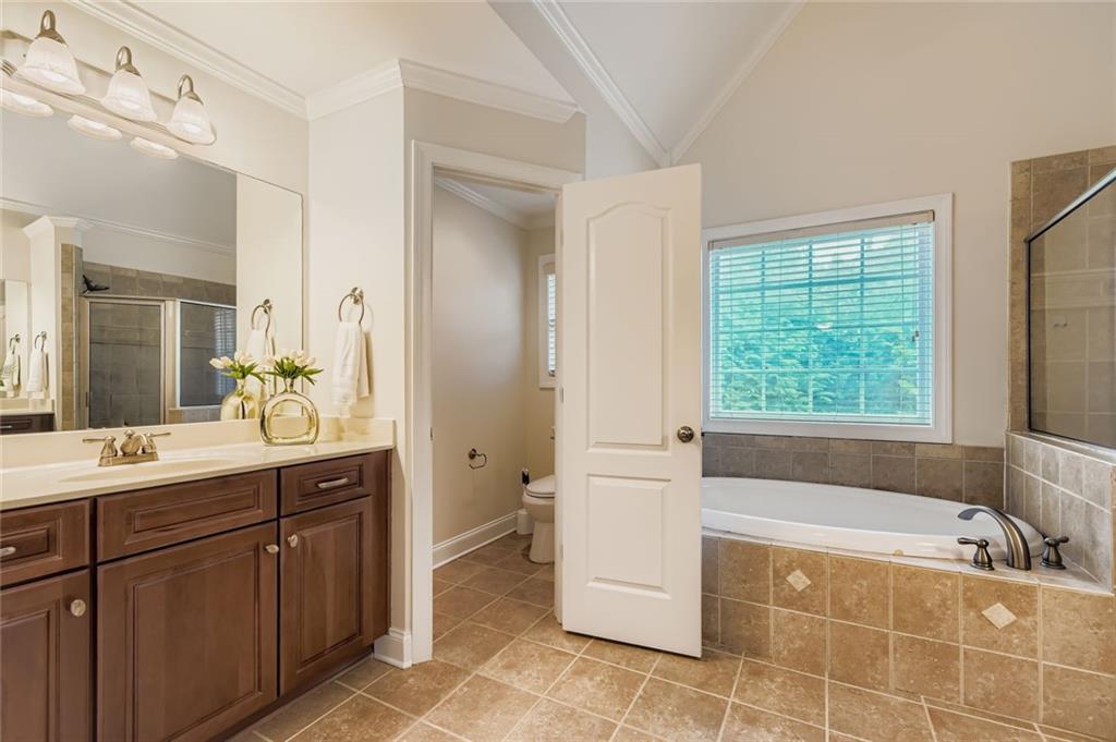 7641 Capps Ridge Lane Douglasville, GA 30135 - Photo 15 of 26 a spacious bathroom with a tub sink and mirror