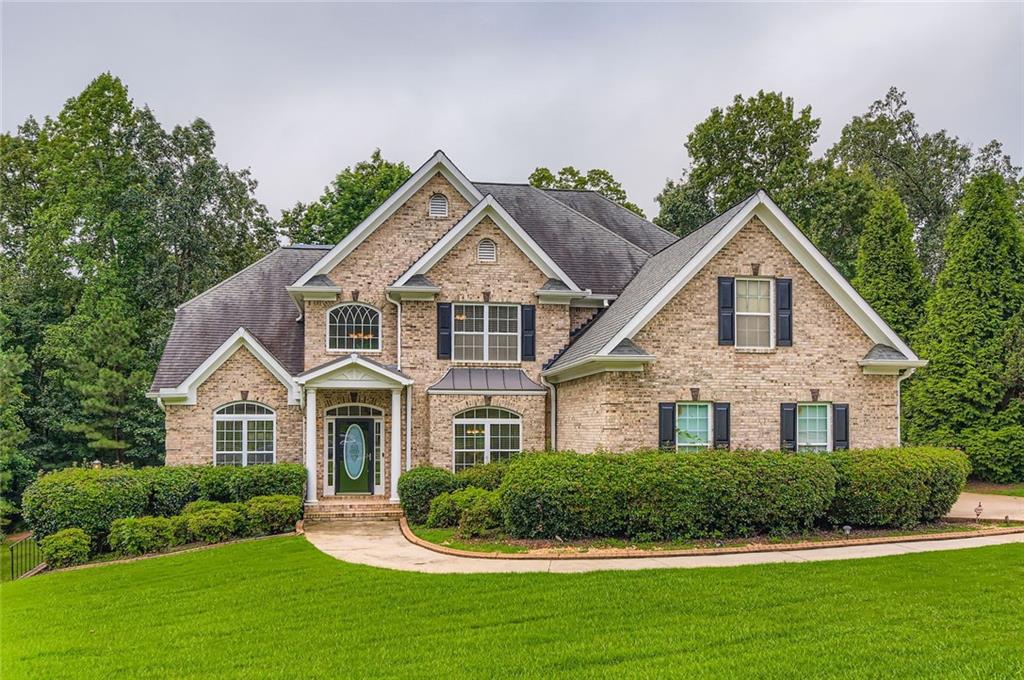 7641 Capps Ridge Lane Douglasville, GA 30135 - Photo 2 of 26 a front view of a house with a yard