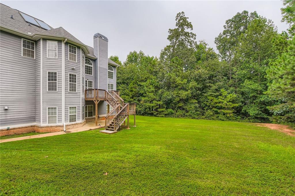 7641 Capps Ridge Lane Douglasville, GA 30135 - Photo 25 of 26 a front view of a house with a yard and trees