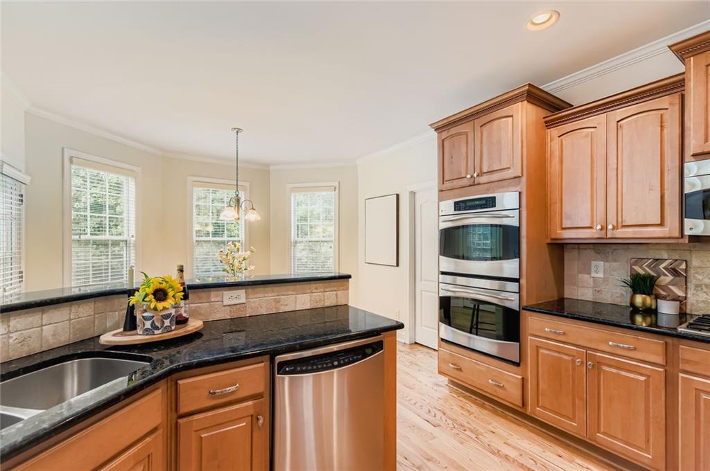 7641 Capps Ridge Lane Douglasville, GA 30135 - Photo 7 of 26 a kitchen with granite countertop a sink a counter space appliances and cabinets
