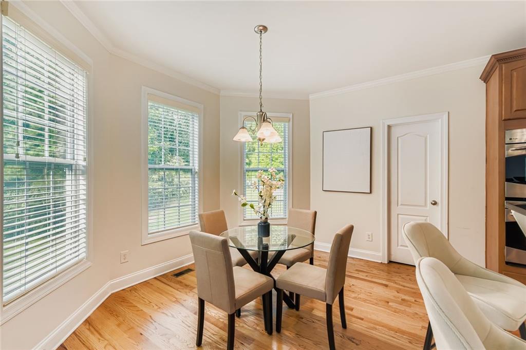 7641 Capps Ridge Lane Douglasville, GA 30135 - Photo 8 of 26 a dining room with furniture a chandelier and wooden floor