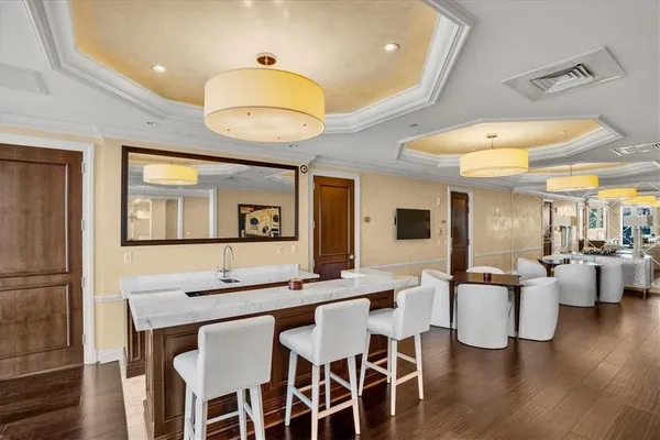 a living room with furniture a flat screen tv and a wall clock