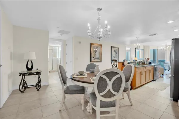 a view of a dining room with furniture and chandelier