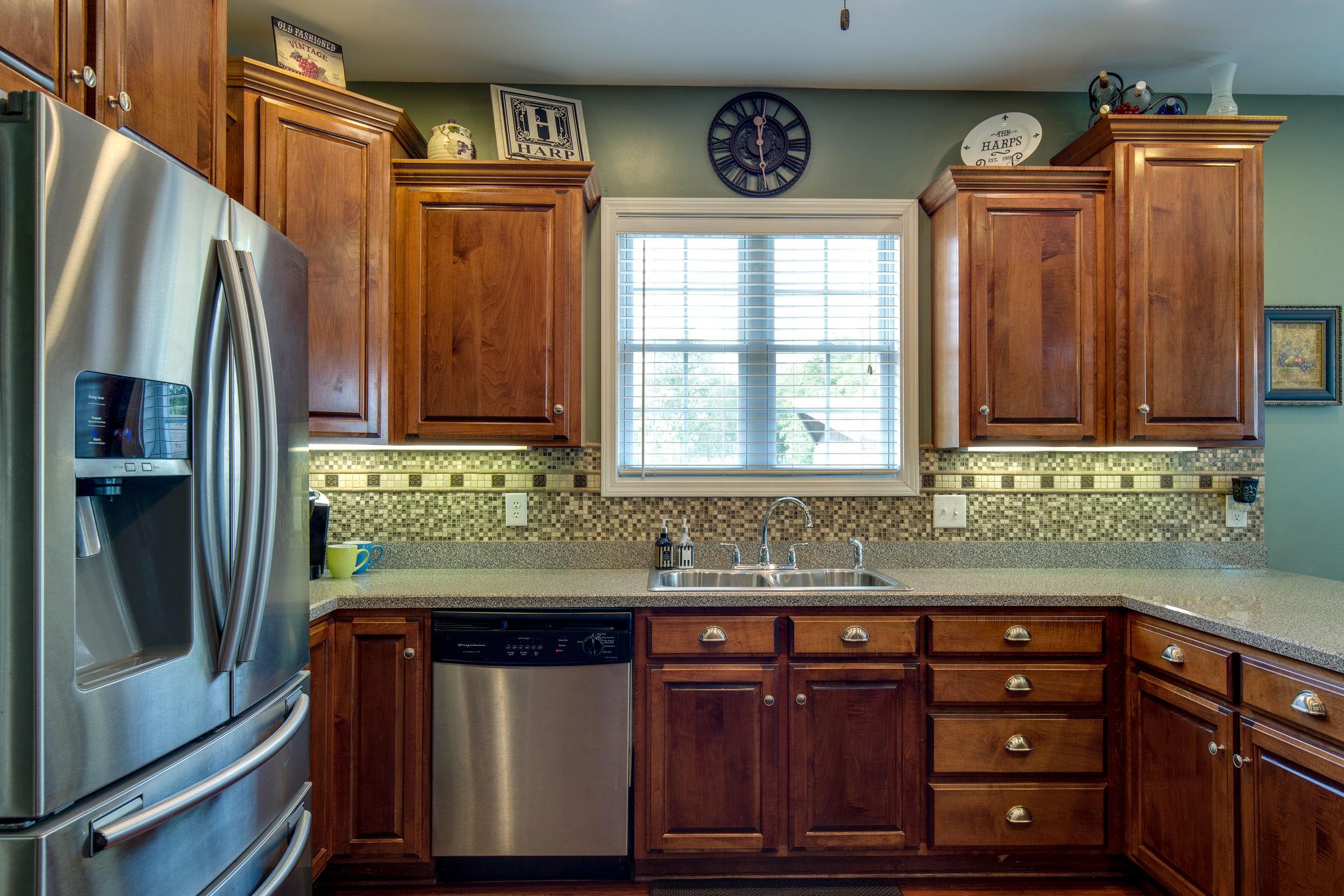 1207 Maple Hill Road Lebanon, TN 37087 - Photo 11 of 29 a kitchen with stainless steel appliances granite countertop a refrigerator and a sink