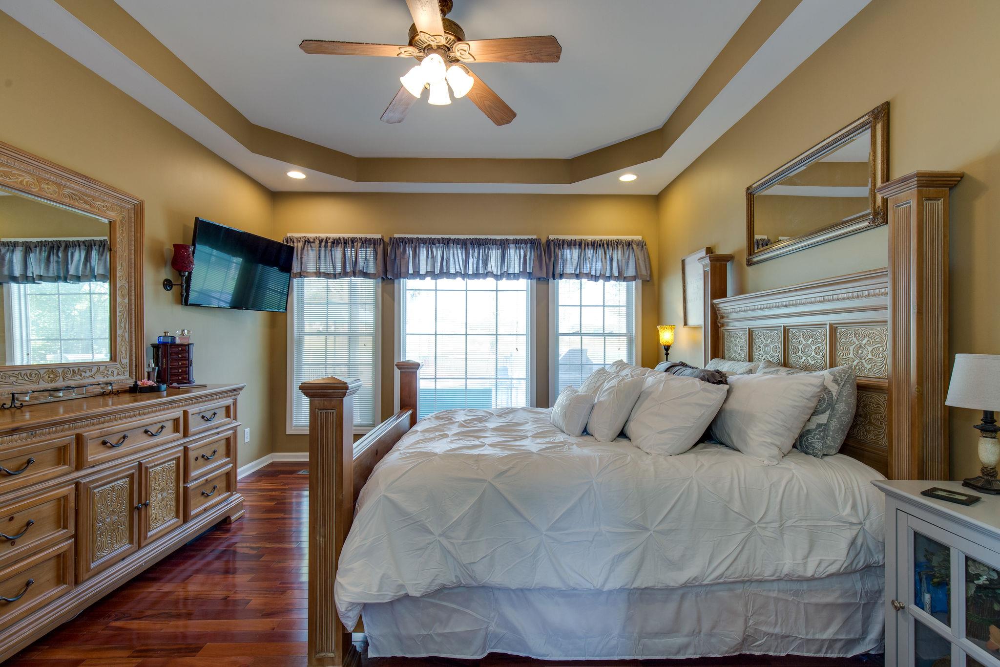 1207 Maple Hill Road Lebanon, TN 37087 - Photo 14 of 29 a bedroom with a bed and wooden floor