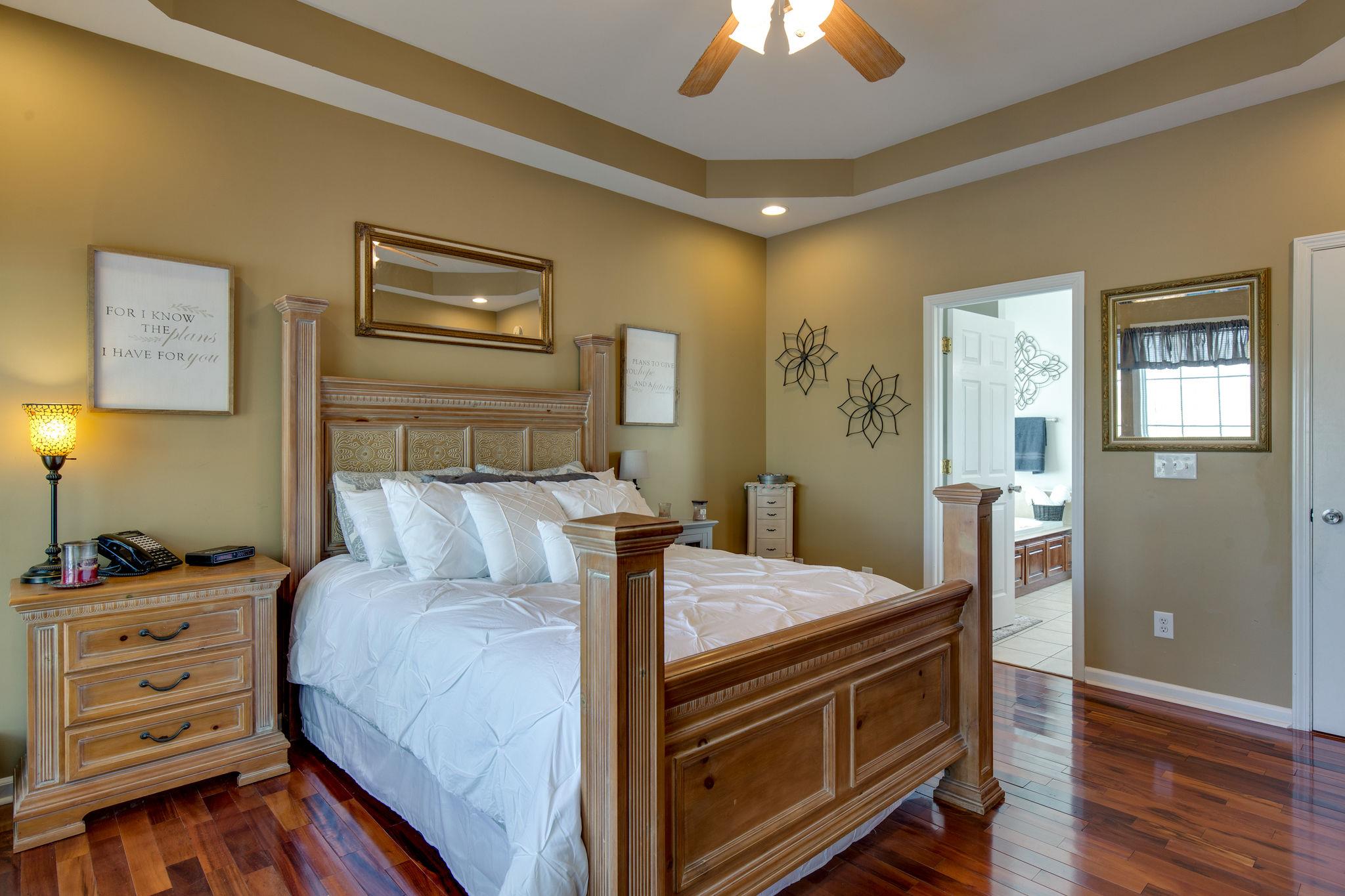 1207 Maple Hill Road Lebanon, TN 37087 - Photo 15 of 29 a bed room with a bed and a chandelier