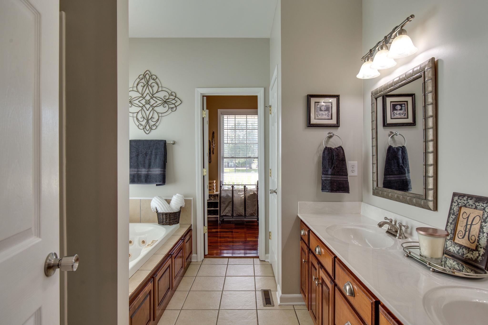 1207 Maple Hill Road Lebanon, TN 37087 - Photo 16 of 29 a en suite bathroom with a granite countertop sink and a large mirror