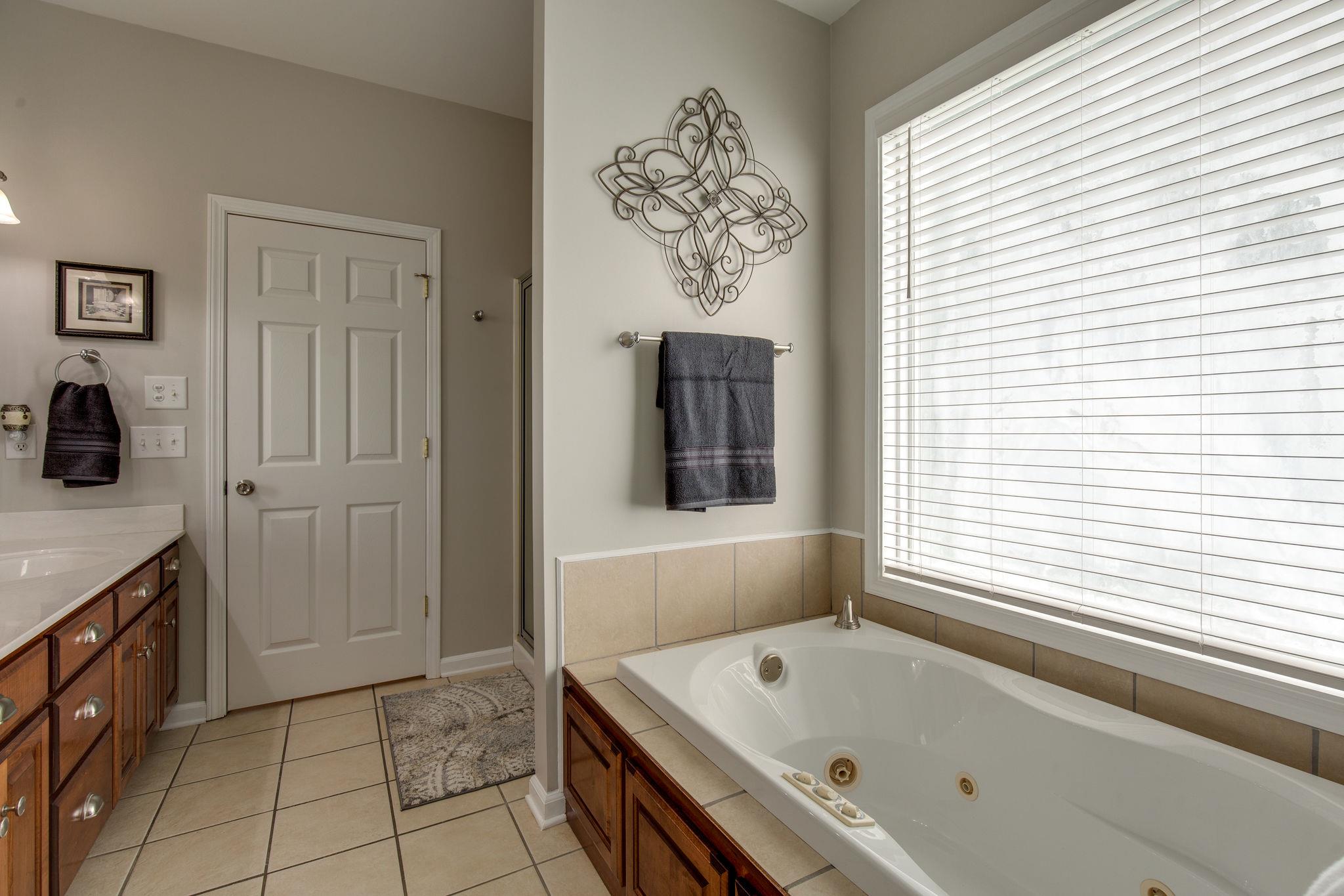 1207 Maple Hill Road Lebanon, TN 37087 - Photo 17 of 29 a bathroom with a tub sink and window