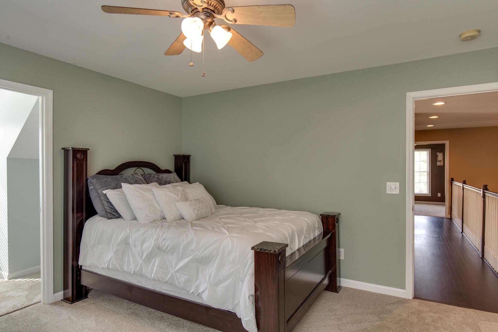 1207 Maple Hill Road Lebanon, TN 37087 - Photo 18 of 29 a bedroom with a bed and a chandelier