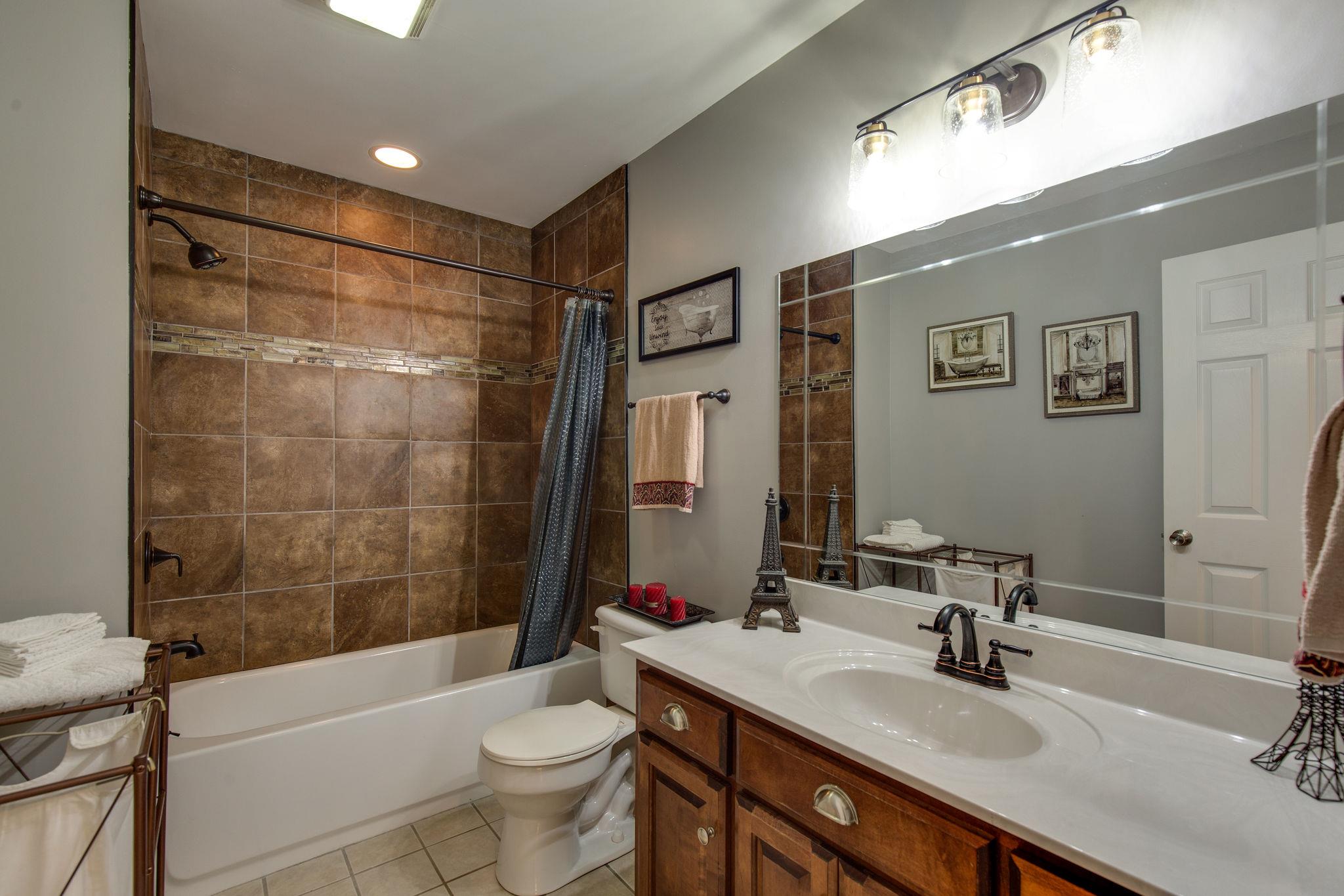 1207 Maple Hill Road Lebanon, TN 37087 - Photo 19 of 29 a bathroom with a sink a toilet and shower