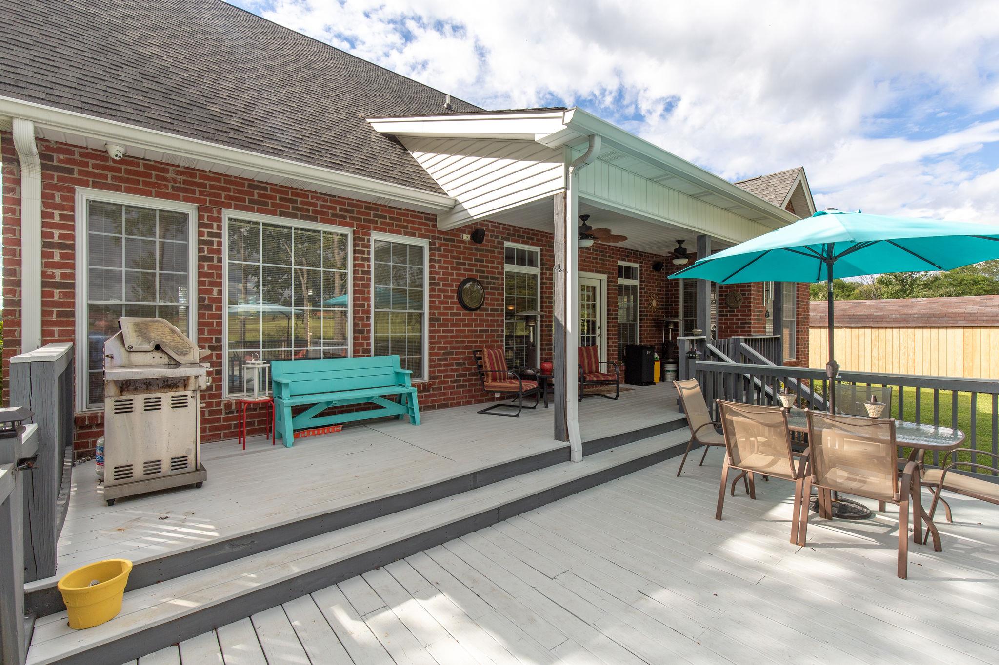 1207 Maple Hill Road Lebanon, TN 37087 - Photo 24 of 29 a view of a patio with a table and chairs under an umbrella