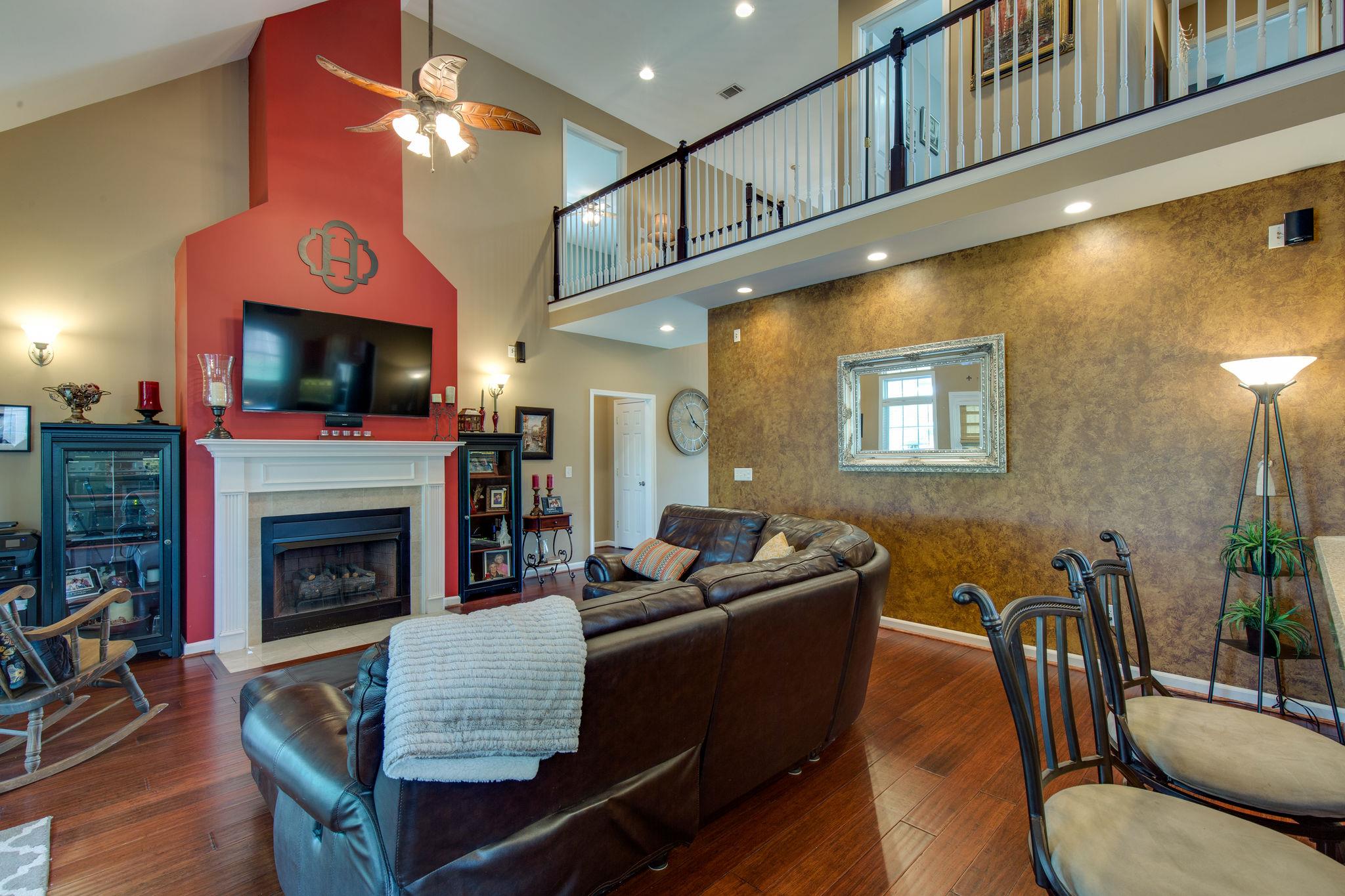 1207 Maple Hill Road Lebanon, TN 37087 - Photo 7 of 29 a living room with furniture a flat screen tv and a fireplace