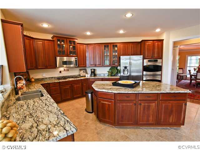 1175 Lickinghole Road Goochland, VA 23063 - Photo 2 of 24 a kitchen with kitchen island granite countertop a sink counter top space appliances and cabinets