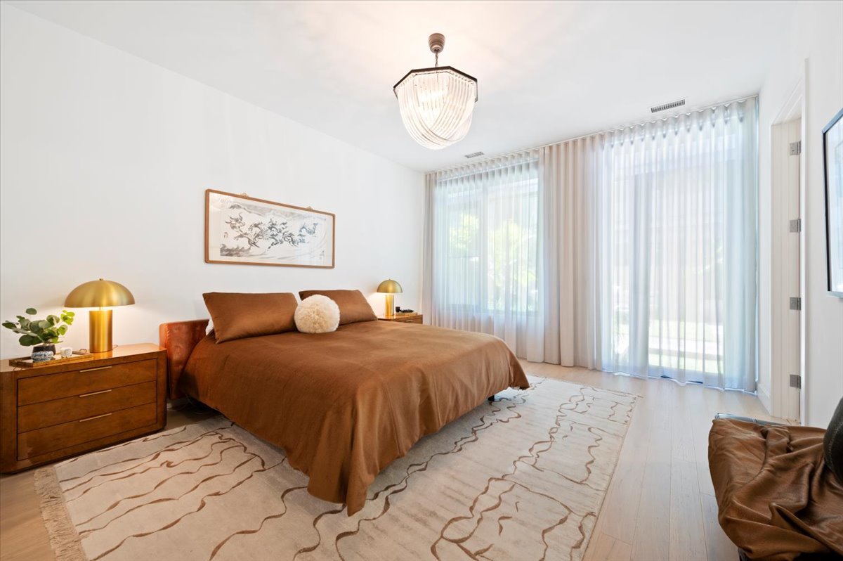 36 North Carpenter Street, Unit 2N Chicago, IL 60607 - Photo 16 of 26 a bedroom with a bed and a chandelier