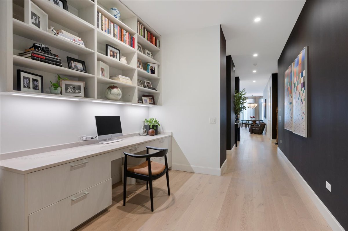 36 North Carpenter Street, Unit 2N Chicago, IL 60607 - Photo 17 of 26 a hallway with a computer on a desk and book shelf