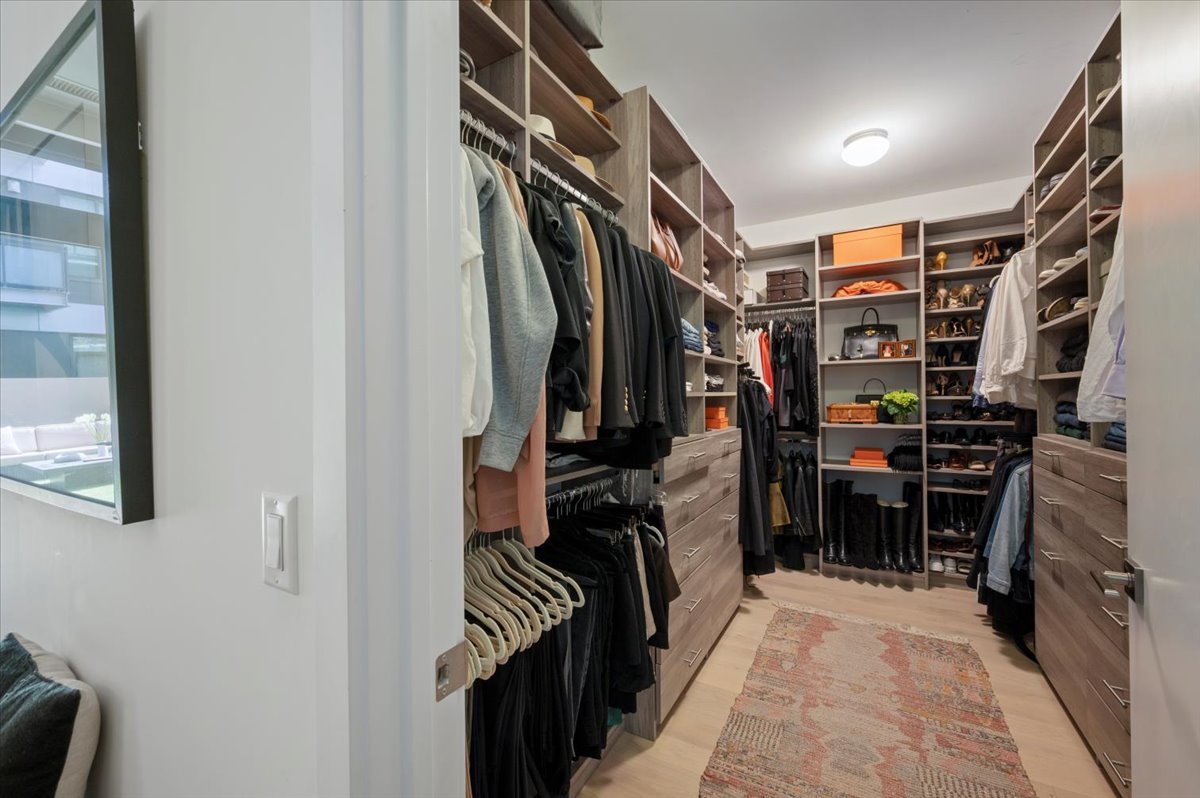 36 North Carpenter Street, Unit 2N Chicago, IL 60607 - Photo 19 of 26 a view of walk in closet with clothes and shoes