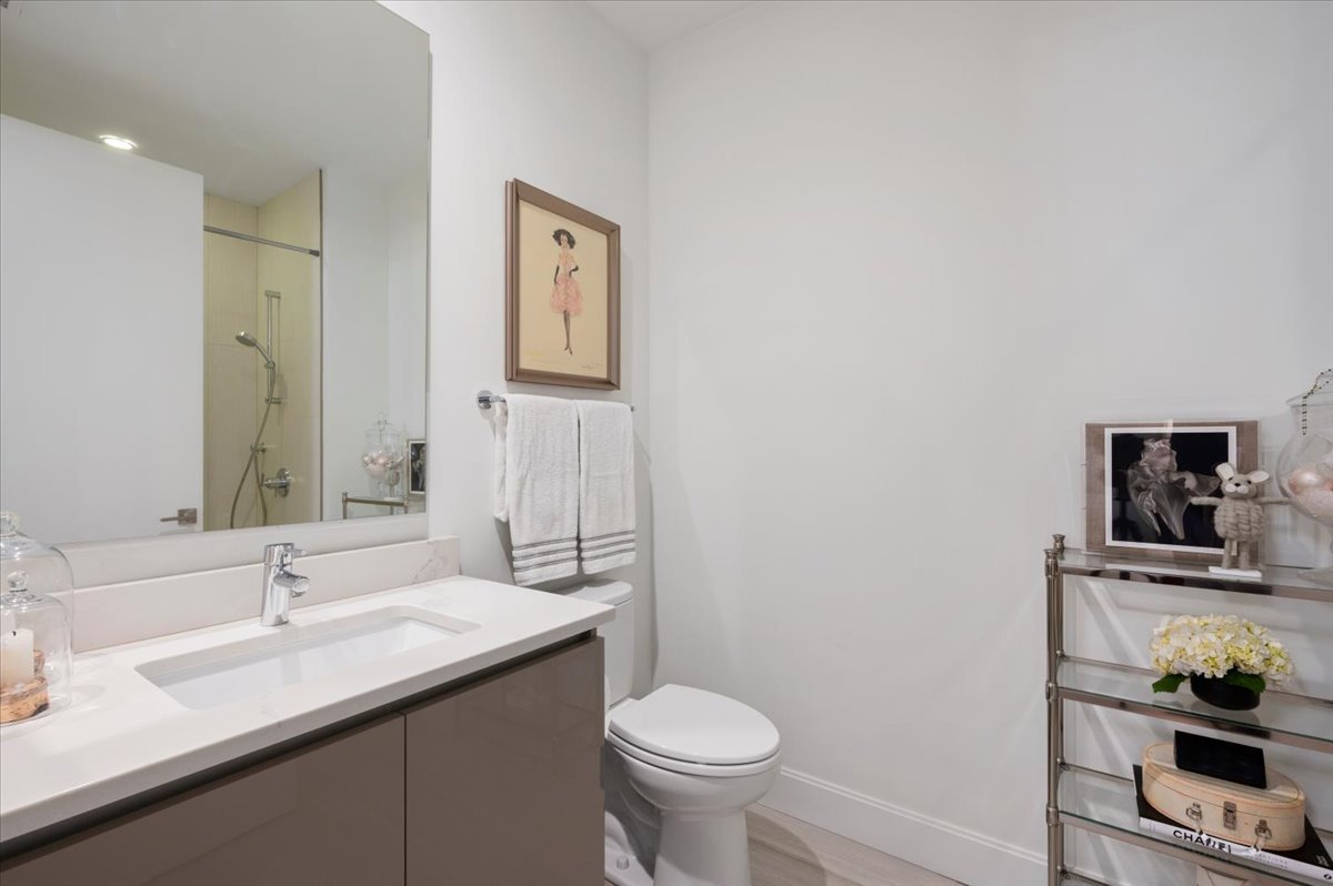 36 North Carpenter Street, Unit 2N Chicago, IL 60607 - Photo 21 of 26 a bathroom with a granite countertop toilet sink and mirror