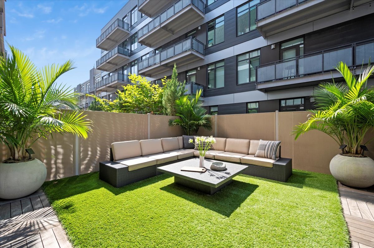 36 North Carpenter Street, Unit 2N Chicago, IL 60607 - Photo 24 of 26 a view of a patio with couches table and chairs potted plants and palm tree