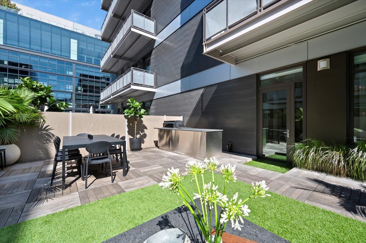 36 North Carpenter Street, Unit 2N Chicago, IL 60607 - Photo 25 of 26 a view of a patio with table and chairs potted plants and floor to ceiling window and potted plants