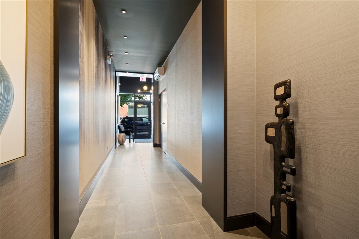 36 North Carpenter Street, Unit 2N Chicago, IL 60607 - Photo 3 of 26 a view of a hallway with wooden floor and a living room