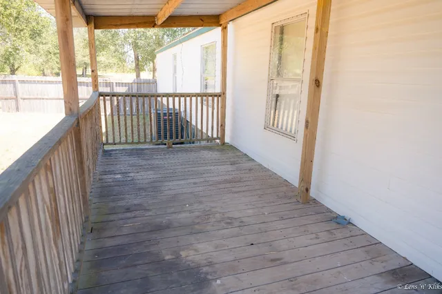 a view of a porch with wooden floor and stairs