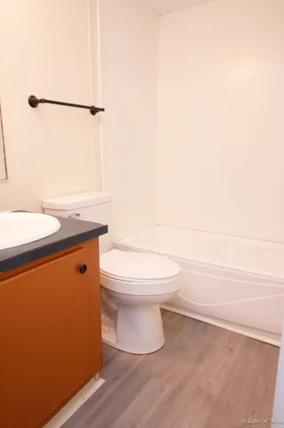 a bathroom with a toilet a sink and shower