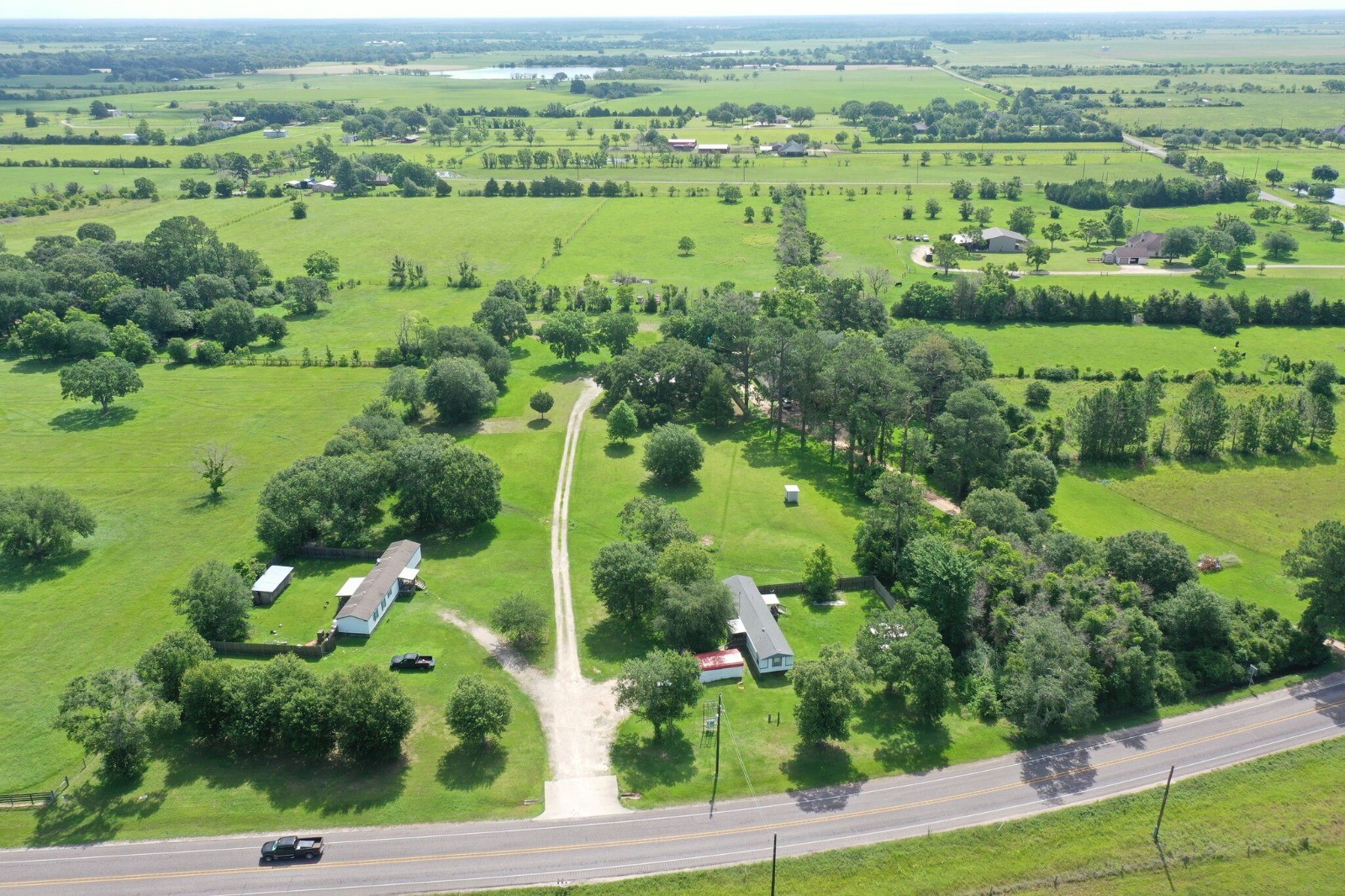 24106 Farm To Market 362 Waller, TX 77484 - Photo 8 of 41 an aerial view of green landscape with trees houses and lake view