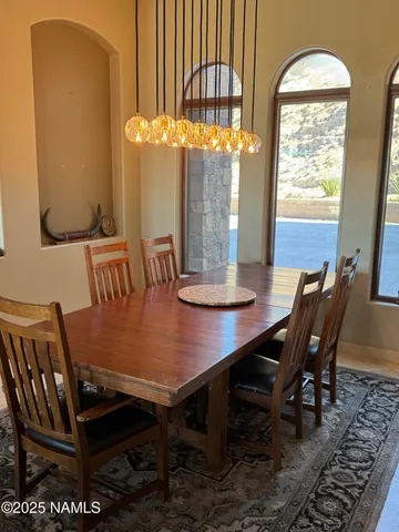 a view of a dining room with furniture window and outside view