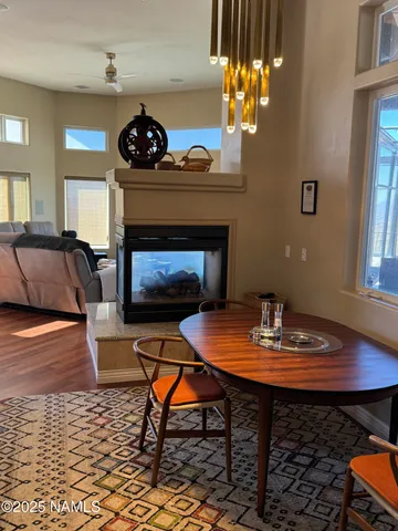 a living room with furniture a table a fireplace and a chandelier