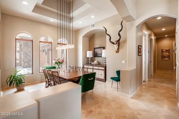 a view of a dining room with furniture and a chandelier