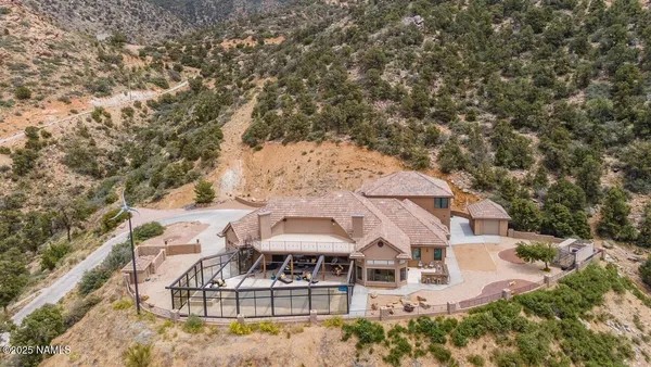 an aerial view of a house with yard swimming pool and outdoor seating