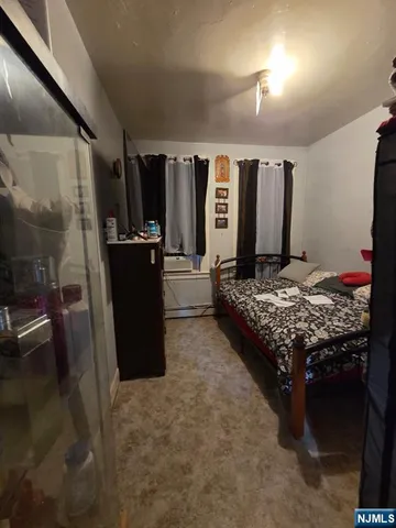 a bedroom with a bed and a mirror