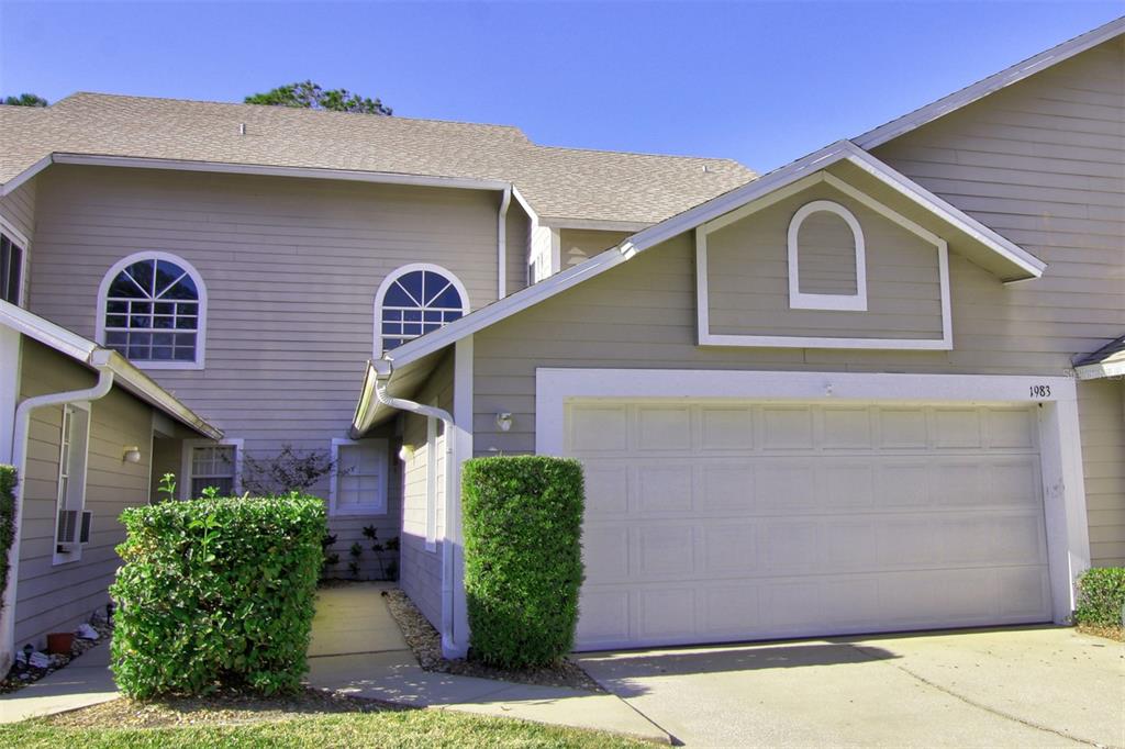 1983 Rutgers Place, Unit 48 Port Orange, FL 32128 - Photo 1 of 1 a front view of a house with garden