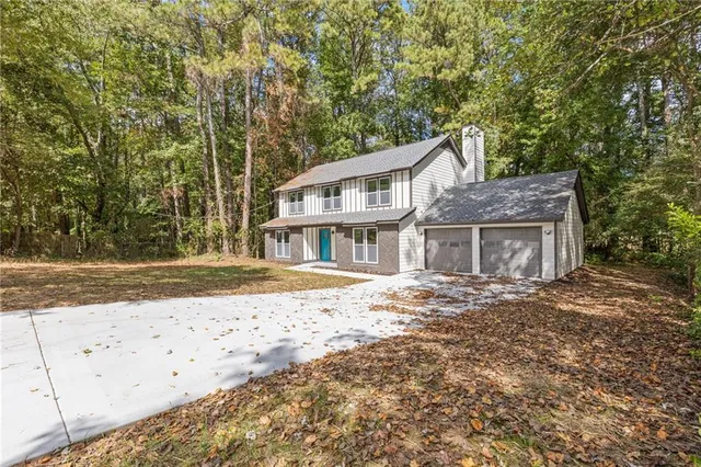 a front view of a house with a garden