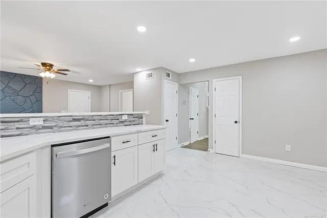 wooden floor fireplace and windows in an empty room