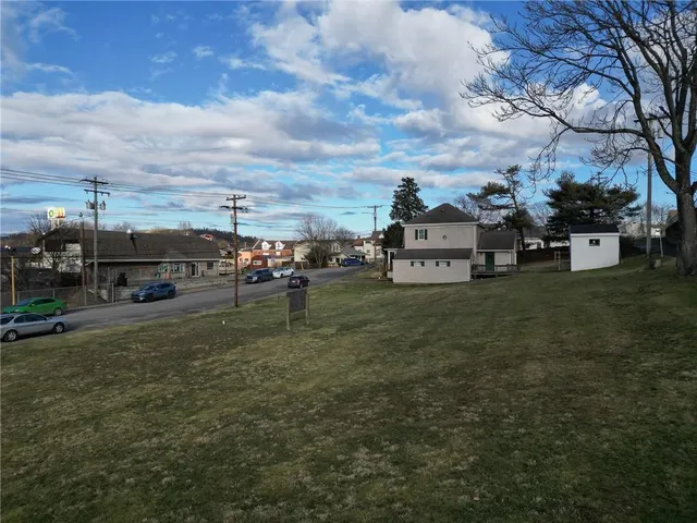 a view of a car park in front of house with a yard