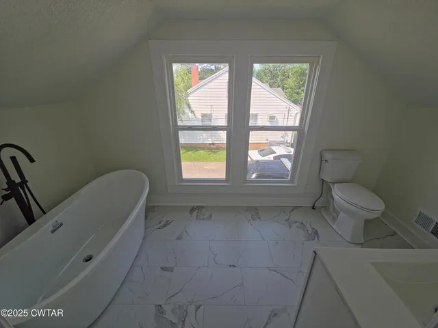 a bathroom with a toilet sink and tub