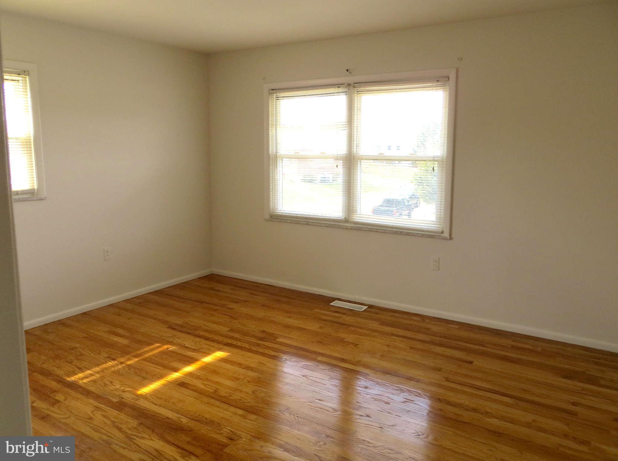 1942 Harewood Road Edgewood, MD 21040 - Photo 9 of 11 a view of an empty room with wooden floor and a window