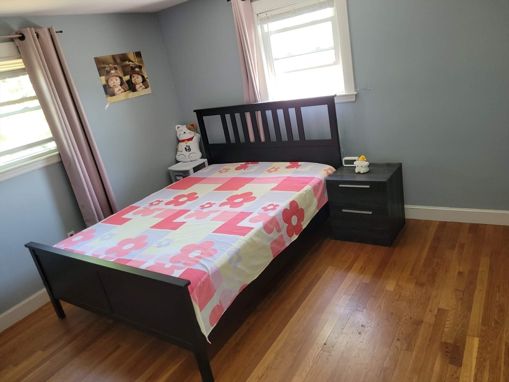 170 Ravenswood Road Waltham, MA 02453 - Photo 16 of 17 a bed sitting in a bedroom next to a window