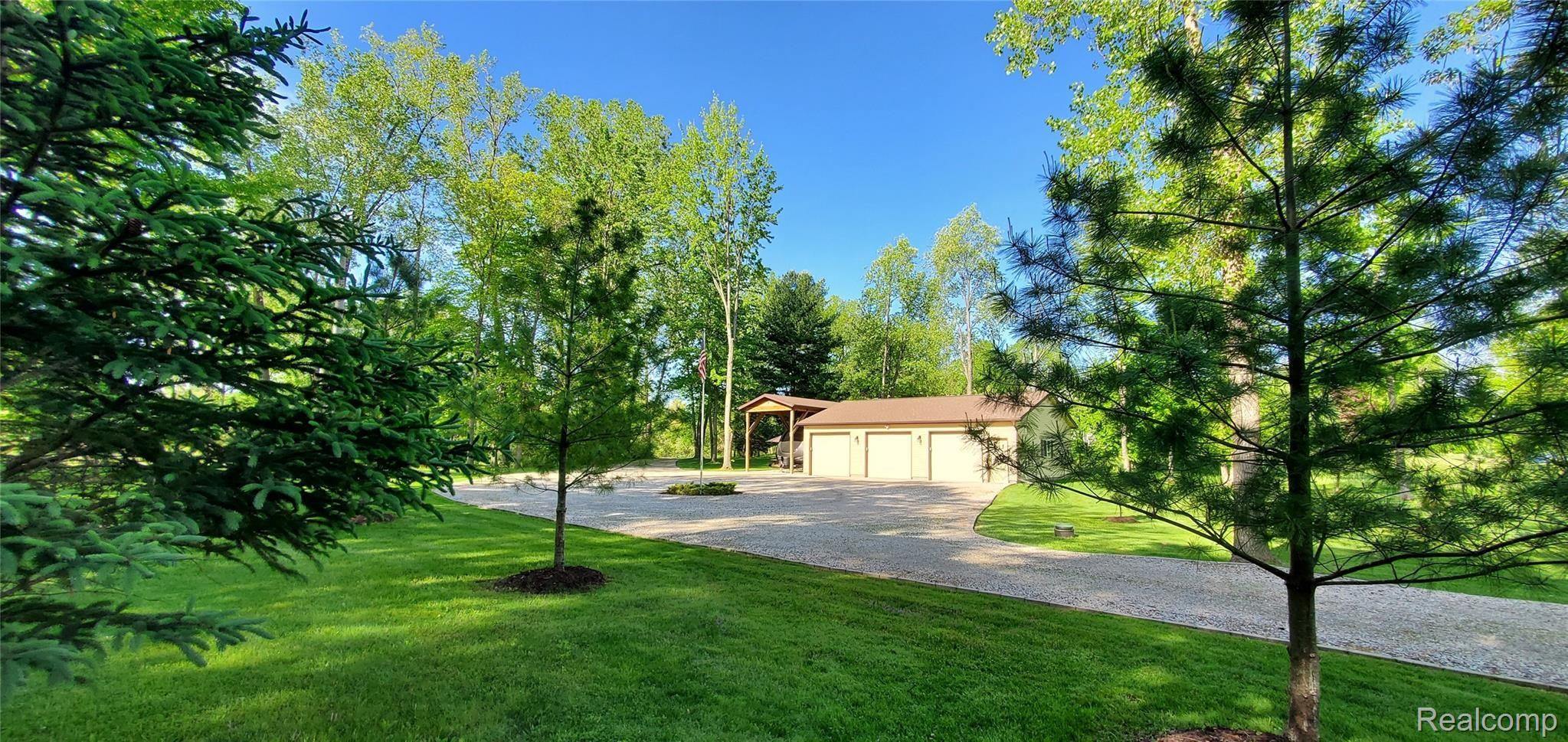 5520 Lowe Road Fowlerville, MI 48836 - Photo 77 of 86 5520 West Lowe Rd View of 3 car garage and tall RV carport