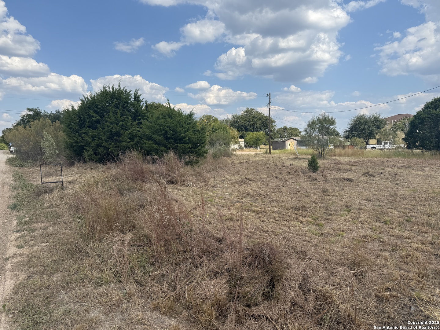 232 Arroyo Drive Bandera, TX 78003 - Photo 4 of 4 a view of a dry yard with trees