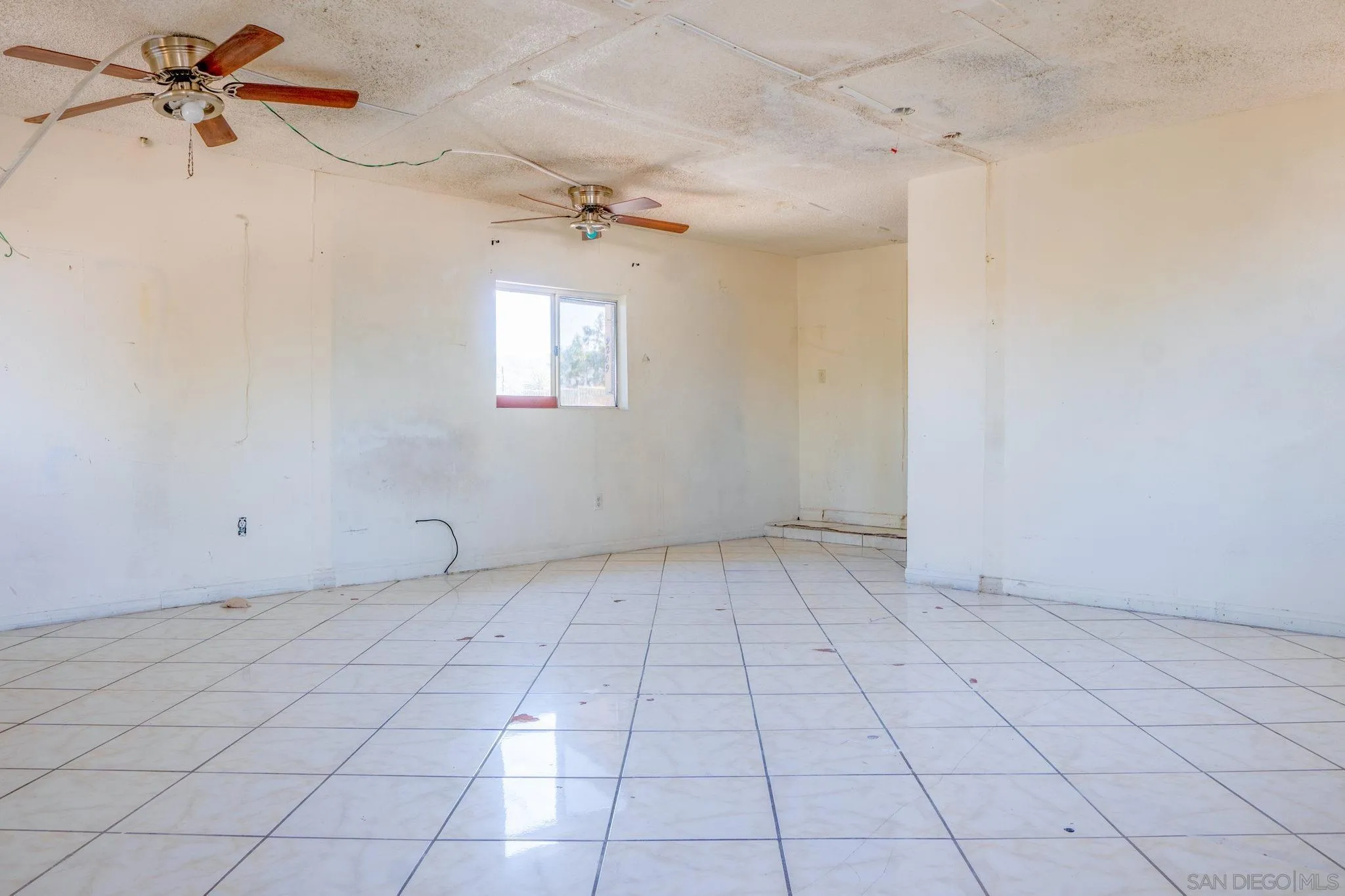 9209 Jamacha Boulevard Spring Valley, CA 91977 - Photo 11 of 26 an empty room with windows and fan