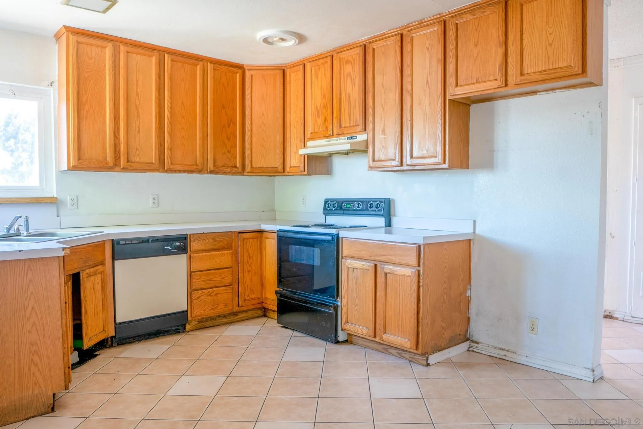 9209 Jamacha Boulevard Spring Valley, CA 91977 - Photo 16 of 26 a kitchen with stainless steel appliances granite countertop a stove a sink and dishwasher