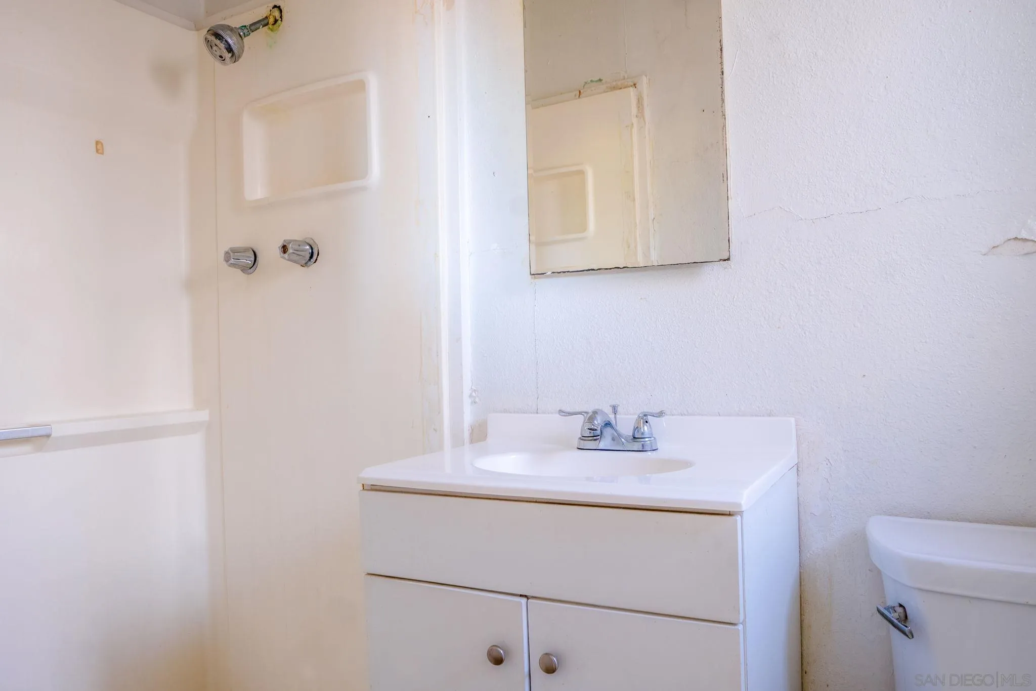 9209 Jamacha Boulevard Spring Valley, CA 91977 - Photo 21 of 26 a bathroom with a sink vanity and mirror