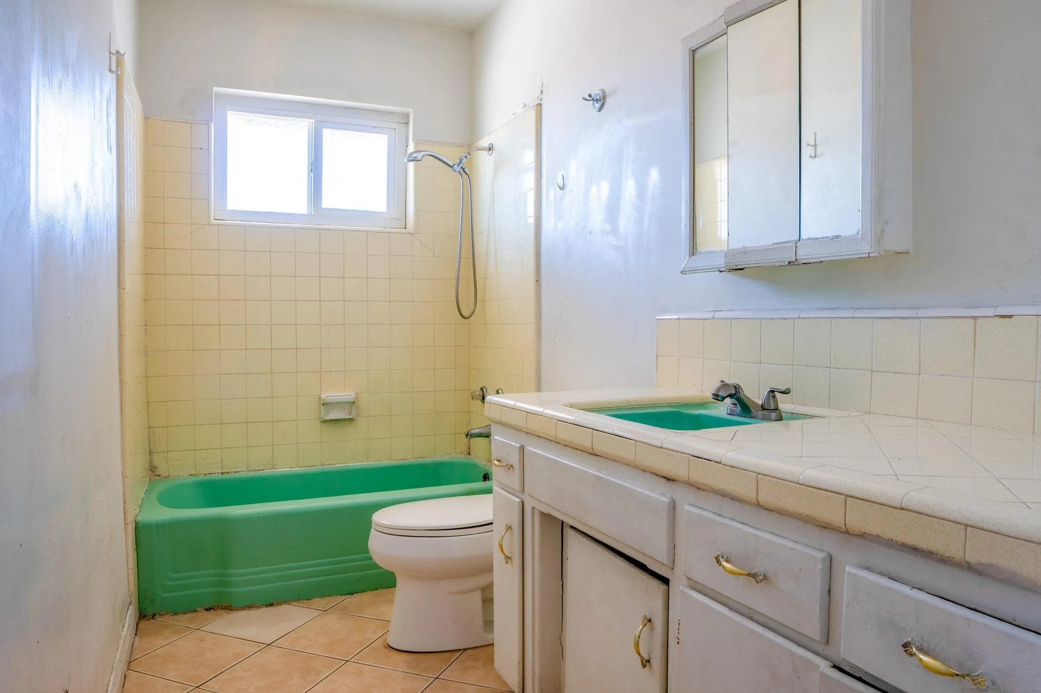 9209 Jamacha Boulevard Spring Valley, CA 91977 - Photo 22 of 26 a bathroom with a granite countertop toilet sink and mirror