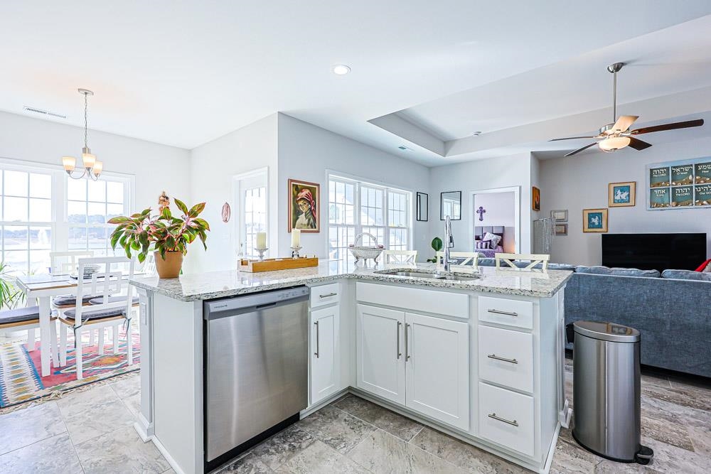 2821 Rivolet Drive Conway, SC 29526 - Photo 34 of 34 Kitchen with dishwasher, light stone counters, white cabinetry, open floor plan, and a kitchen island with sink