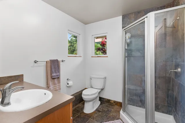 a bathroom with a toilet sink and shower